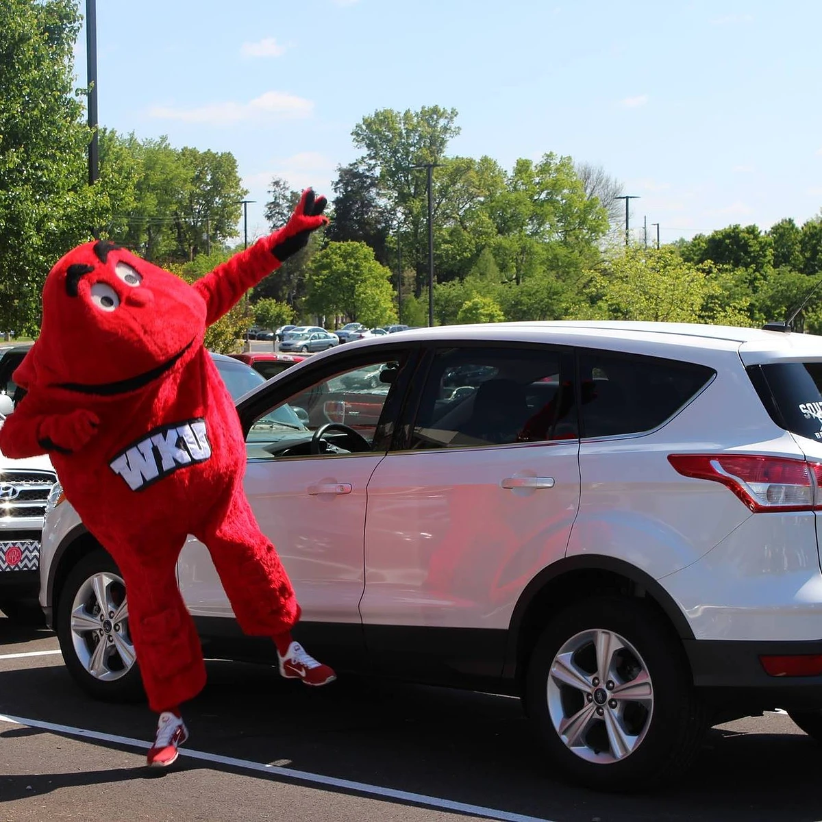 Big Red next to a white care