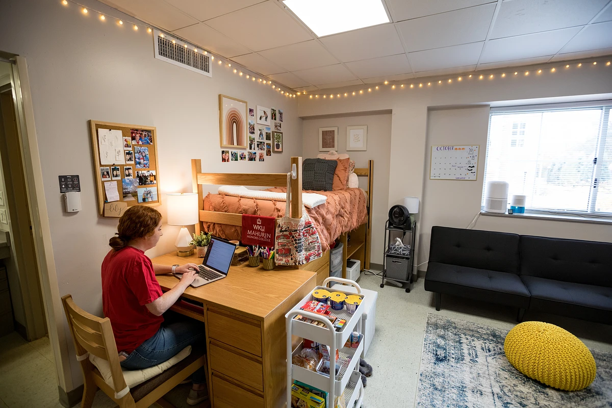 A student working on their computer in a corner room of Southwest Hall