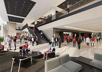 The image depicts a busy, modern atrium with people walking, using stairs, and sitting in lounge areas.
