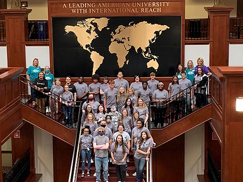 Students standing on a group on stairs